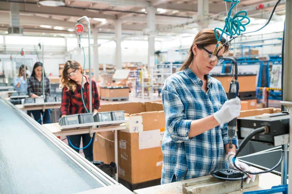 A girl doing her work while wearing safety glasses
